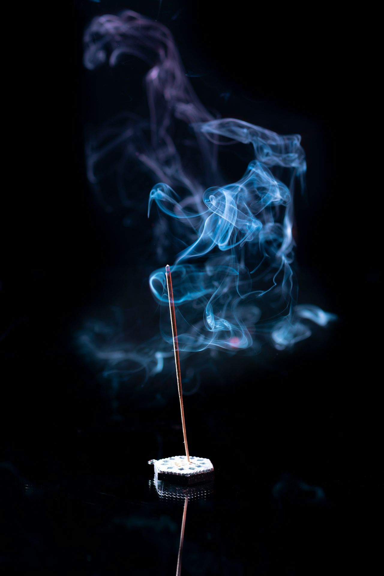 a incense stick with smoke coming out of it